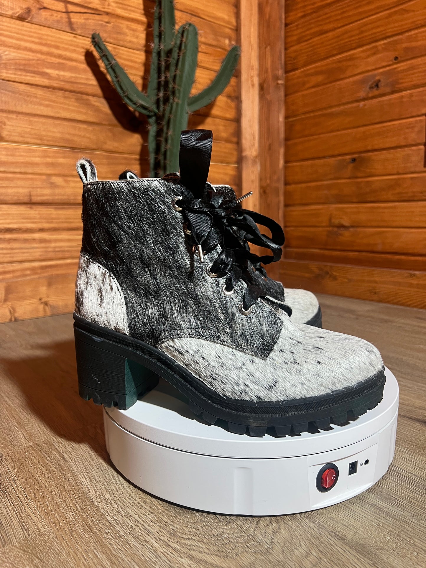Black and white cowhide combat boots